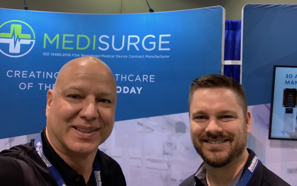 Rick Shorey and a fellow MediSurge team member take a selfie in front of MediSurge signage at MD&M 2020 in Anaheim, California.